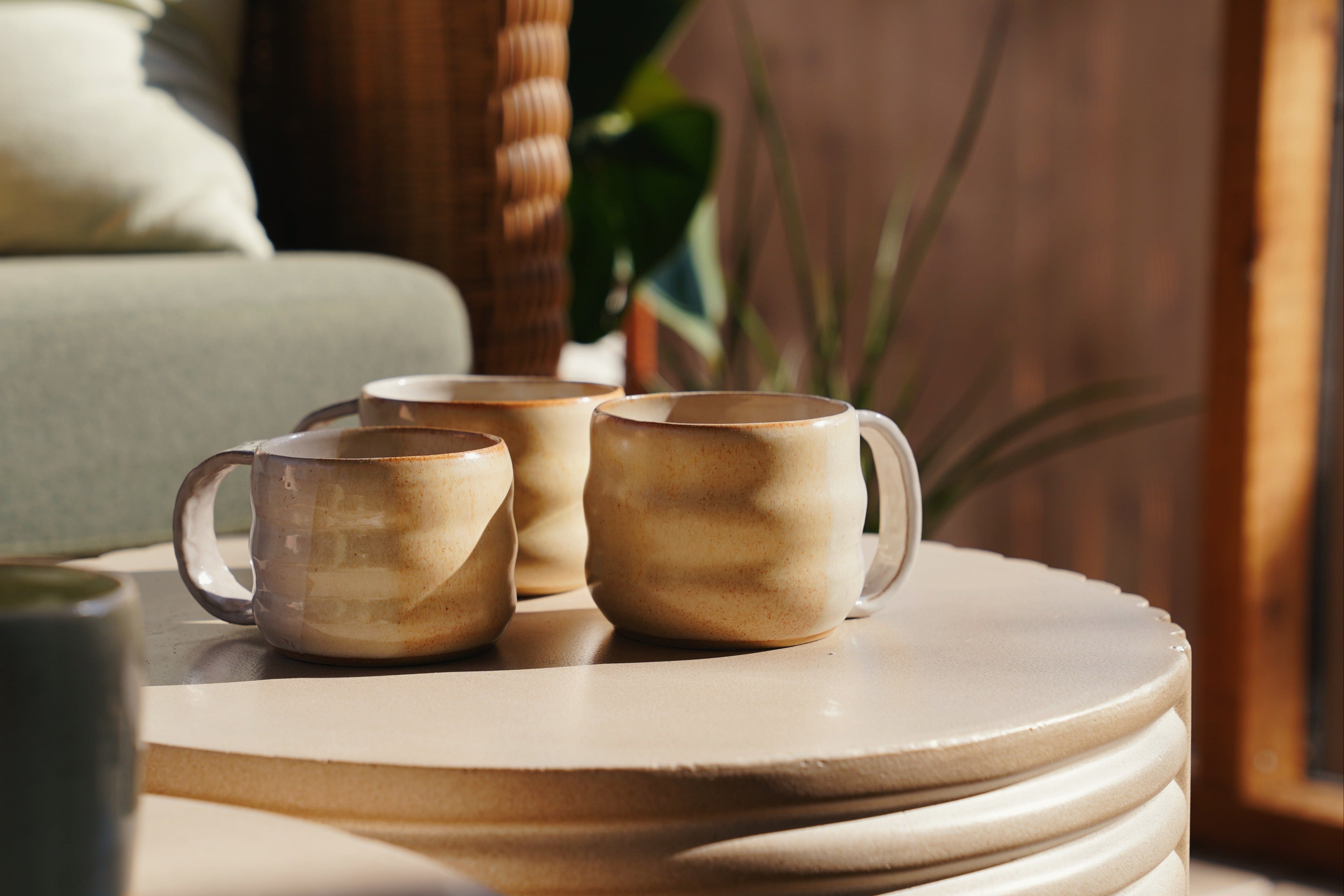 Ceramic mugs on a stone surface with a blurred background