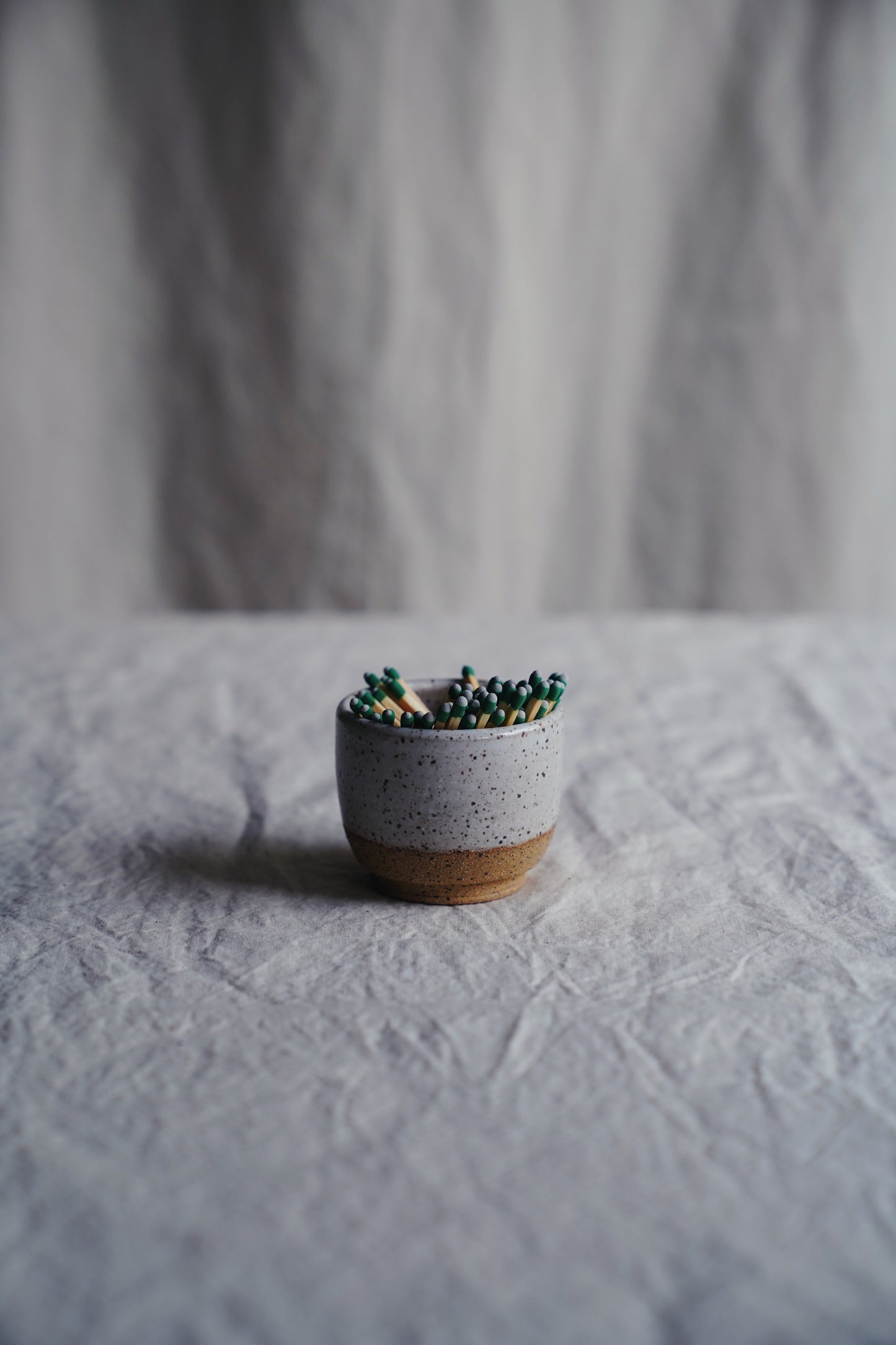 white speckled match holder